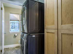 Laundry area featuring stacked washer / drying machine