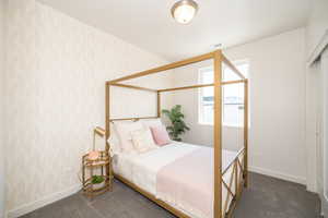 Bedroom featuring dark colored carpet