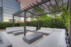 Patio terrace at dusk featuring outdoor lounge area and a pergola