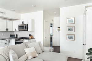 Living room with dark hardwood / wood-style flooring