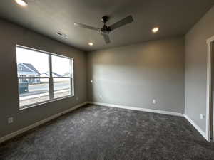 Carpeted spare room with ceiling fan