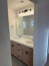 Bathroom with vanity, a shower, tile patterned floors, and a textured ceiling