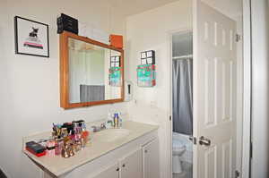 Full bathroom with vanity, toilet, and shower / bath combo with shower curtain