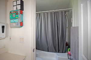 Bathroom featuring shower / tub combo with curtain