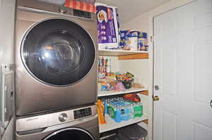 Clothes washing area featuring stacked washer / drying machine