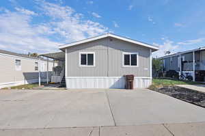 View of side of home with a carport