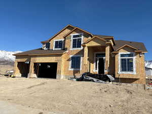 Unfinished property with a garage, a mountain view, and central air condition unit