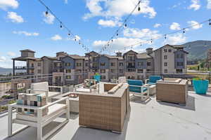 View of patio featuring a mountain view and an outdoor living space with a fire pit