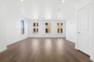 Unfurnished living room featuring a fireplace and dark wood-type flooring