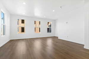 Spare room with dark wood-type flooring