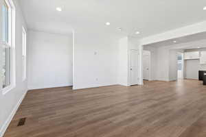 Unfurnished living room featuring dark hardwood / wood-style flooring