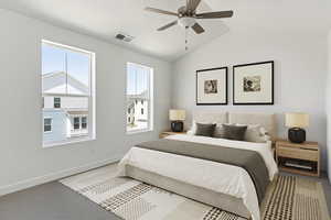 Carpeted bedroom featuring ceiling fan, vaulted ceiling, and multiple windows