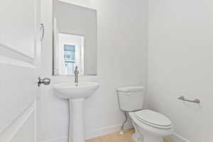 Bathroom with toilet and tile patterned flooring