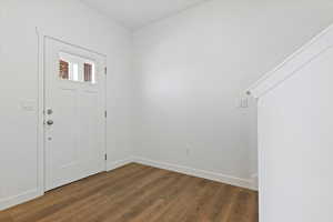 Entryway with dark hardwood / wood-style flooring