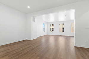 Unfurnished living room featuring dark hardwood / wood-style floors