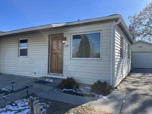 View of front of property featuring an outbuilding and a garage