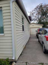 View of side of home featuring an outdoor structure and a garage