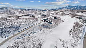 Snowy aerial view featuring a mountain view