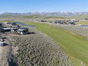Drone / aerial view of a water and mountain view and a local golf course