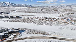 Snowy aerial view featuring a mountain view