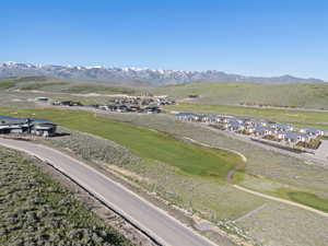 Aerial view of a mountainous background and a golf course