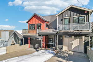 View of front facade with a balcony and a garage