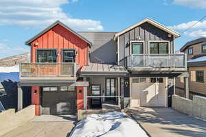 View of front facade with a balcony and a garage