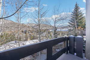 Snow covered back of property featuring a mountain view