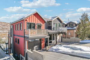 View of front facade featuring a balcony and a garage