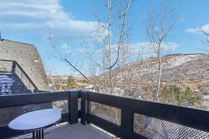 Snow covered back of property featuring a mountain view