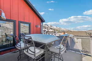 Snow covered patio with a mountain view