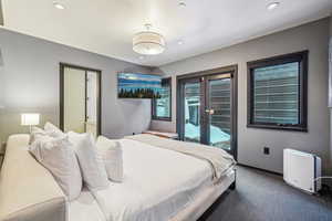 Carpeted bedroom featuring access to exterior and french doors