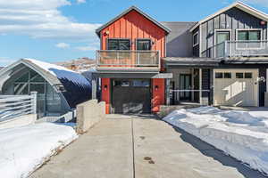 View of front of home with a balcony and a garage