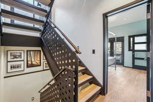 Staircase featuring a wealth of natural light and hardwood / wood-style floors