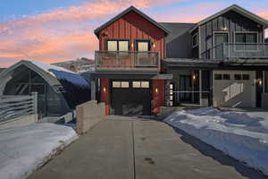 Contemporary home with a balcony and a garage