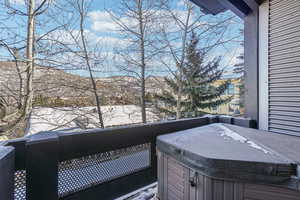 Snow covered deck with a hot tub