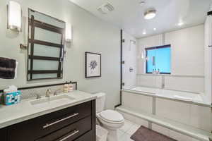 Bathroom featuring vanity, toilet, and tile patterned floors