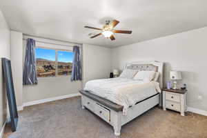 Carpeted bedroom with ceiling fan