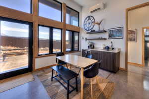 Dining space featuring a wall mounted air conditioner