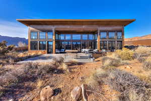 Rear view of house featuring a mountain view and a patio