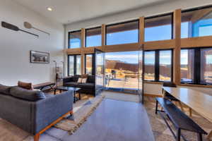 Living room with concrete flooring and a high ceiling