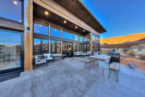 Patio terrace at dusk featuring a mountain view and an outdoor hangout area