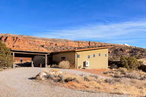 View of front facade with a mountain view and a carport