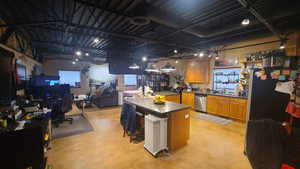 Kitchen with a kitchen island, sink, a kitchen bar, and dishwasher