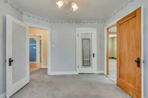 Unfurnished bedroom featuring light colored carpet and a closet