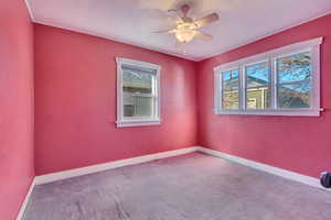 Spare room with ceiling fan and carpet floors