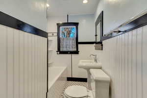 Bathroom featuring toilet and a bath