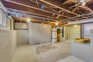 Basement featuring heating unit and water heater