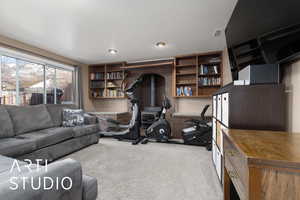 Interior space with a wood stove and light carpet