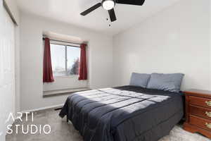 Bedroom featuring ceiling fan, a closet, and light carpet